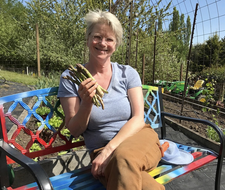 Elizabeth holding asparagus in the garden